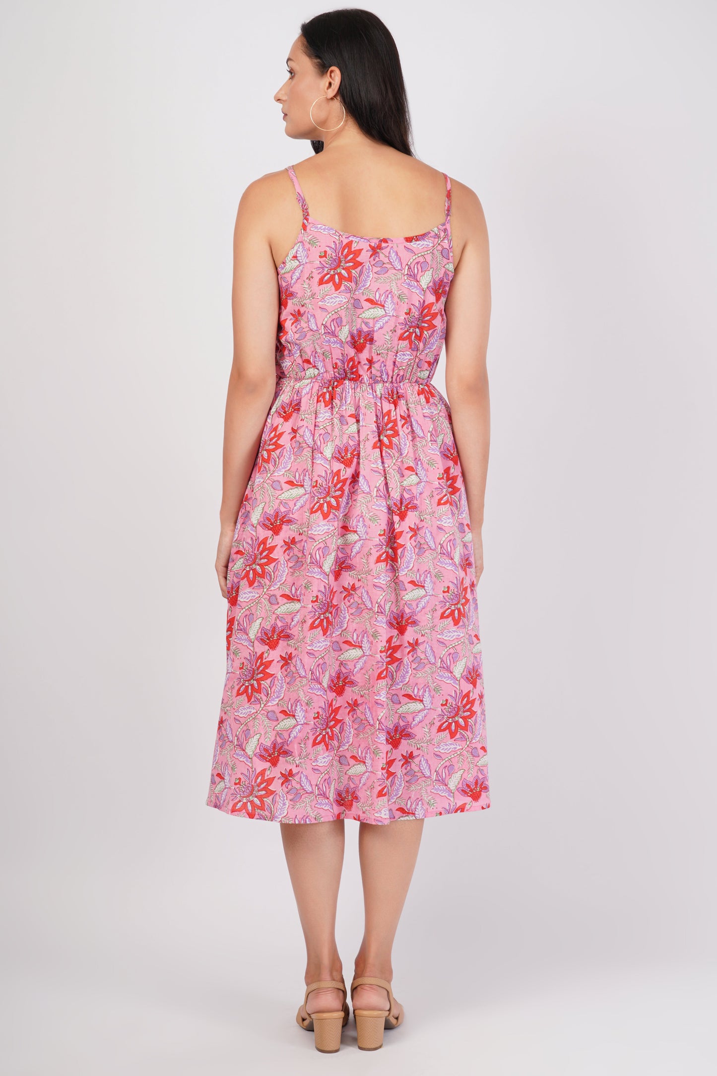 Woman wearing a pink floral dress on a white background